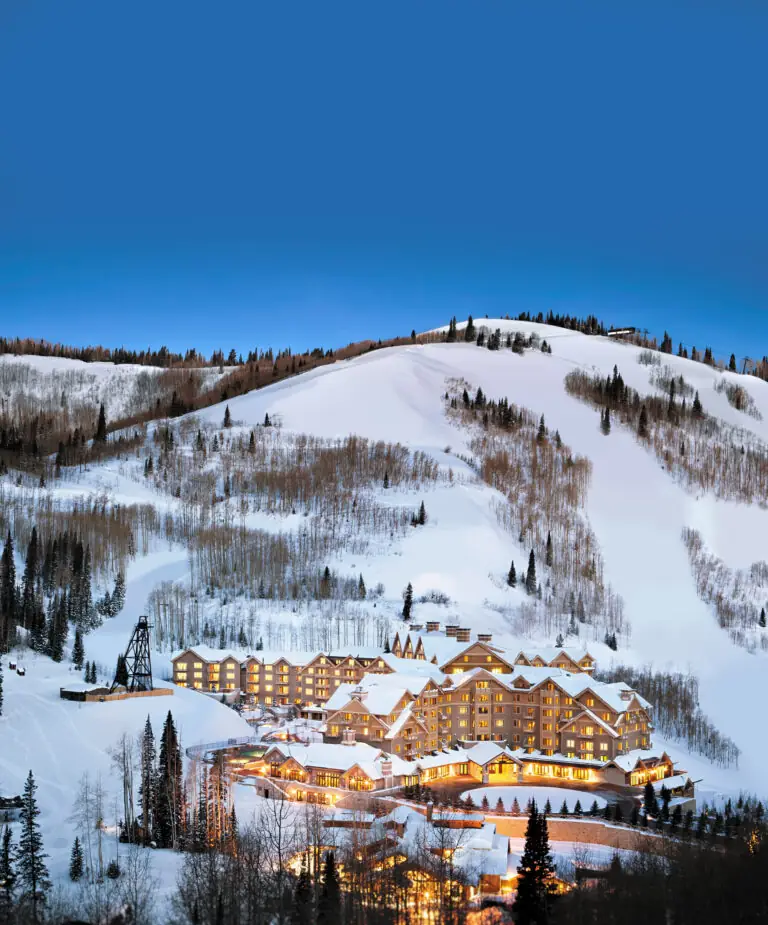 Montage Deer Valley at dusk with snow covered mountains framing the luxury resort.