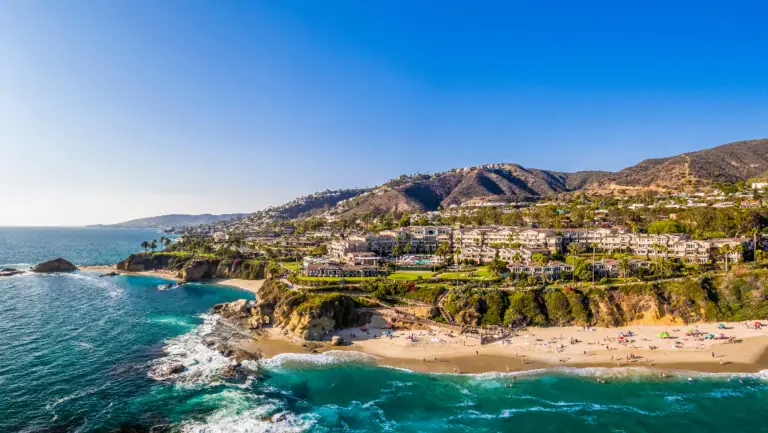 Montage Laguna Beach perched on a coastal bluff above shimmering blue ocean waters.