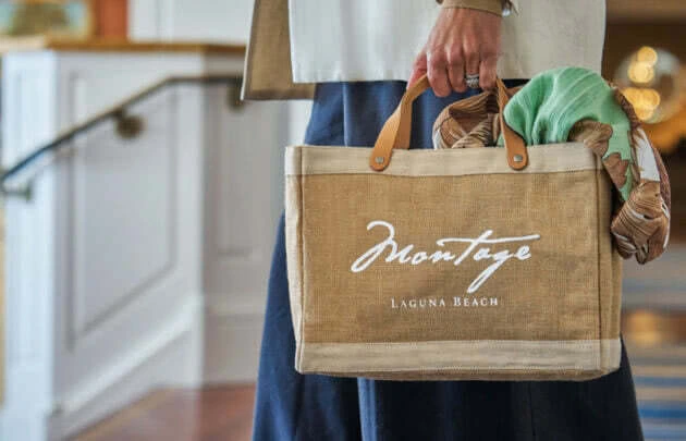 Woman carrying a Montage Laguna Beach shopping bag