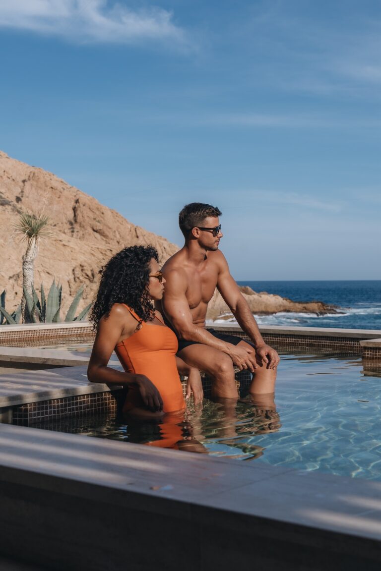 A couple sitting by the pool at Montage Los Cabos