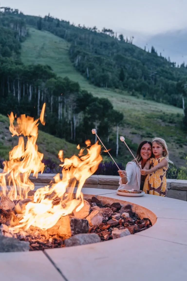 A mother and daughter roasting marshmallows at Montage Deer Valley.