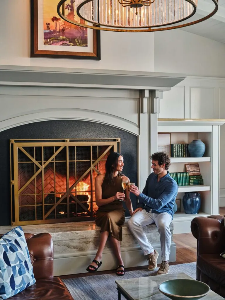 A couple having cocktails by a fire at Montage Laguna Beach
