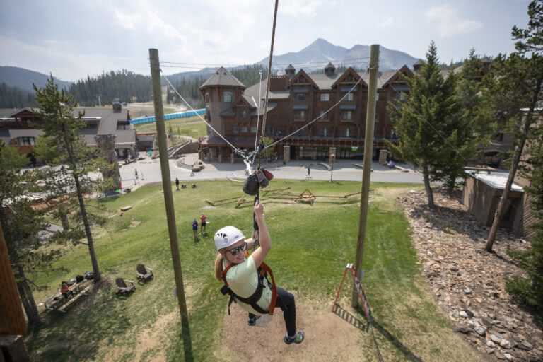 Girl zip lining at Big Sky resort