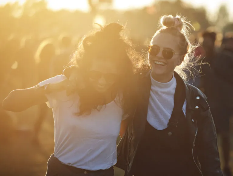 Friends hanging out at big music festival