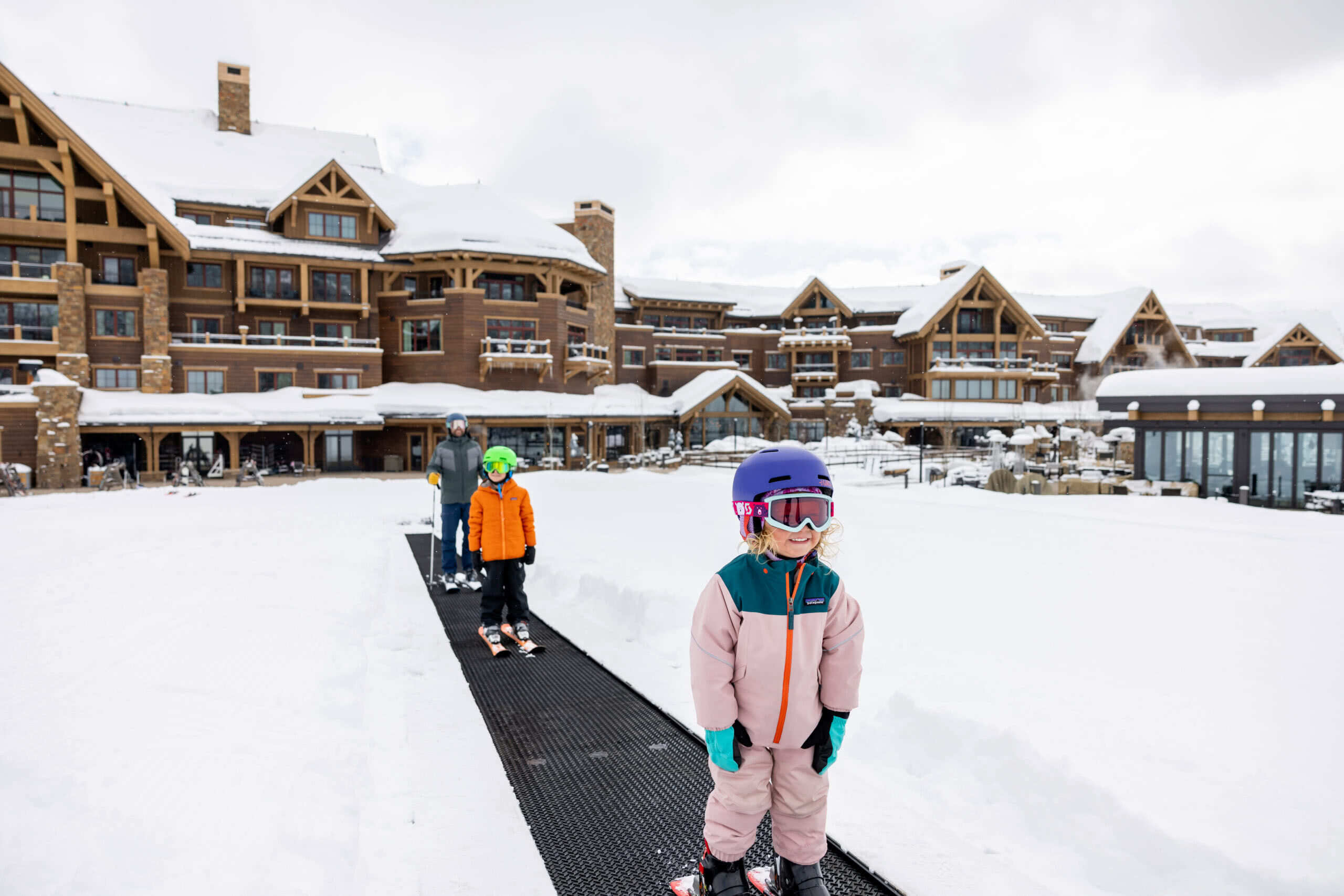 child on the magic carpet on the ski mountain