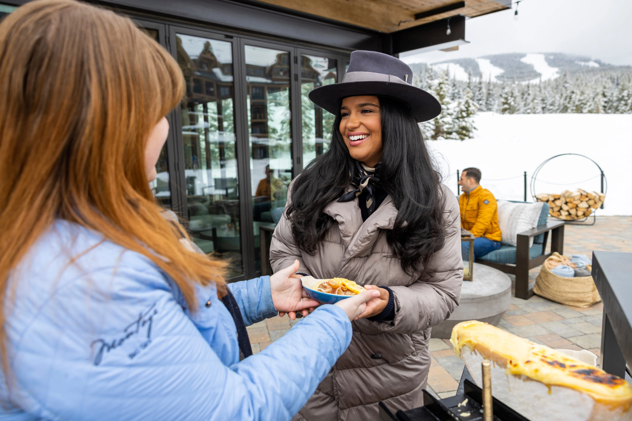 server serving food on an outdoor winter patio