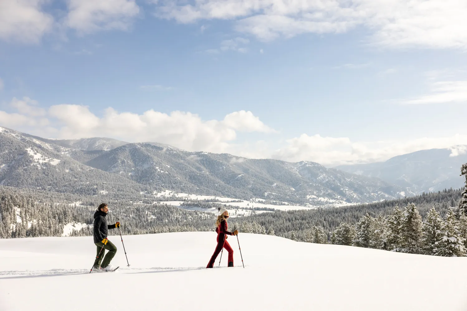 A couple snowshoeing in Big Sky, Montana