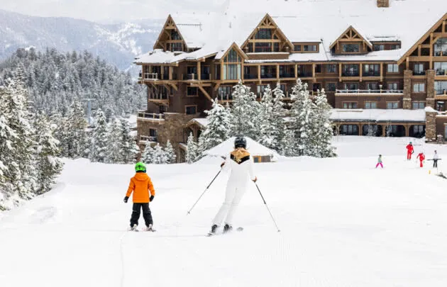 Skiers in front of Montage Big Sky resort