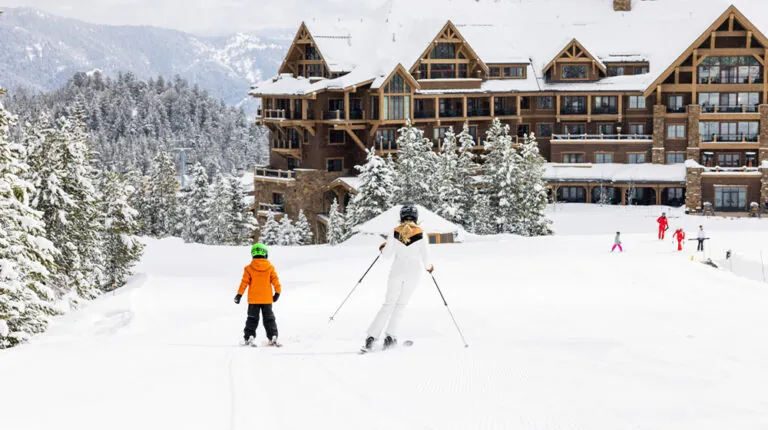 Skiers in front of Montage Big Sky resort