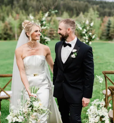 Newlywed couple walking down the aisle at Montana wedding
