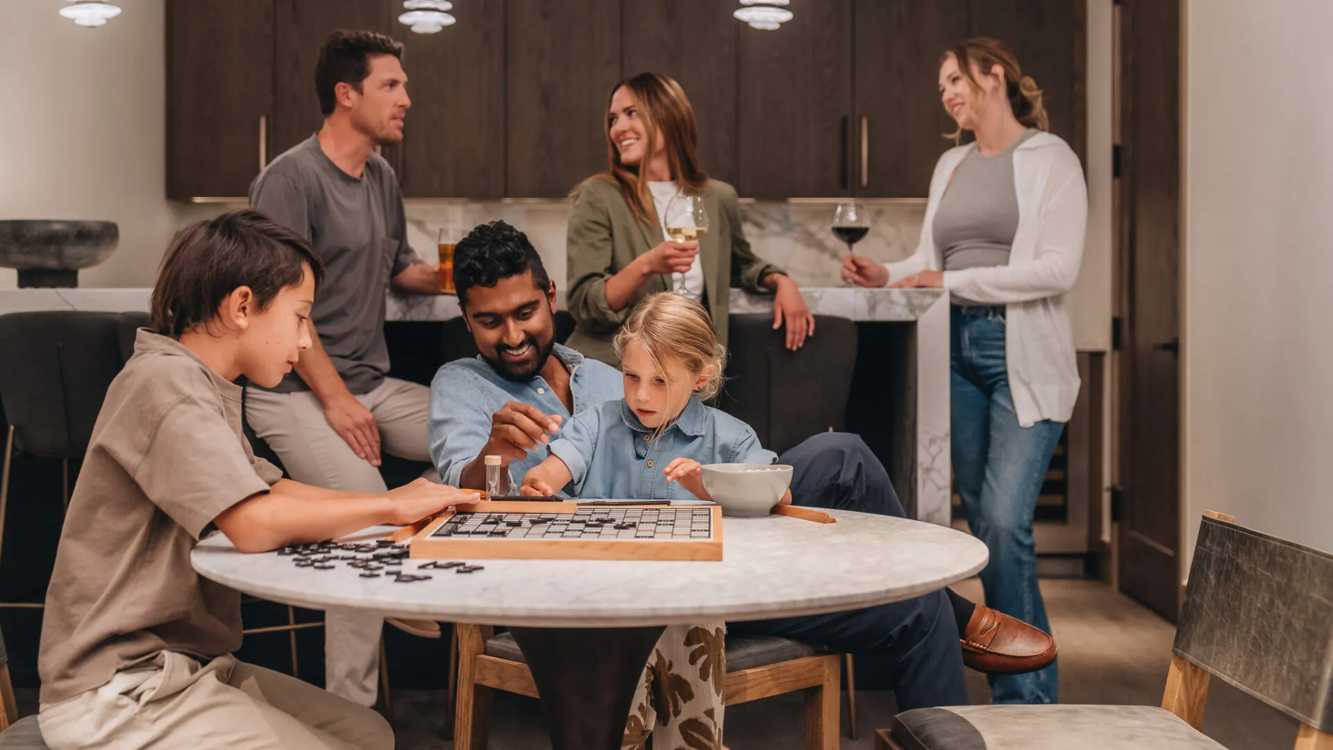 Family and friends playing games in a mountain home.