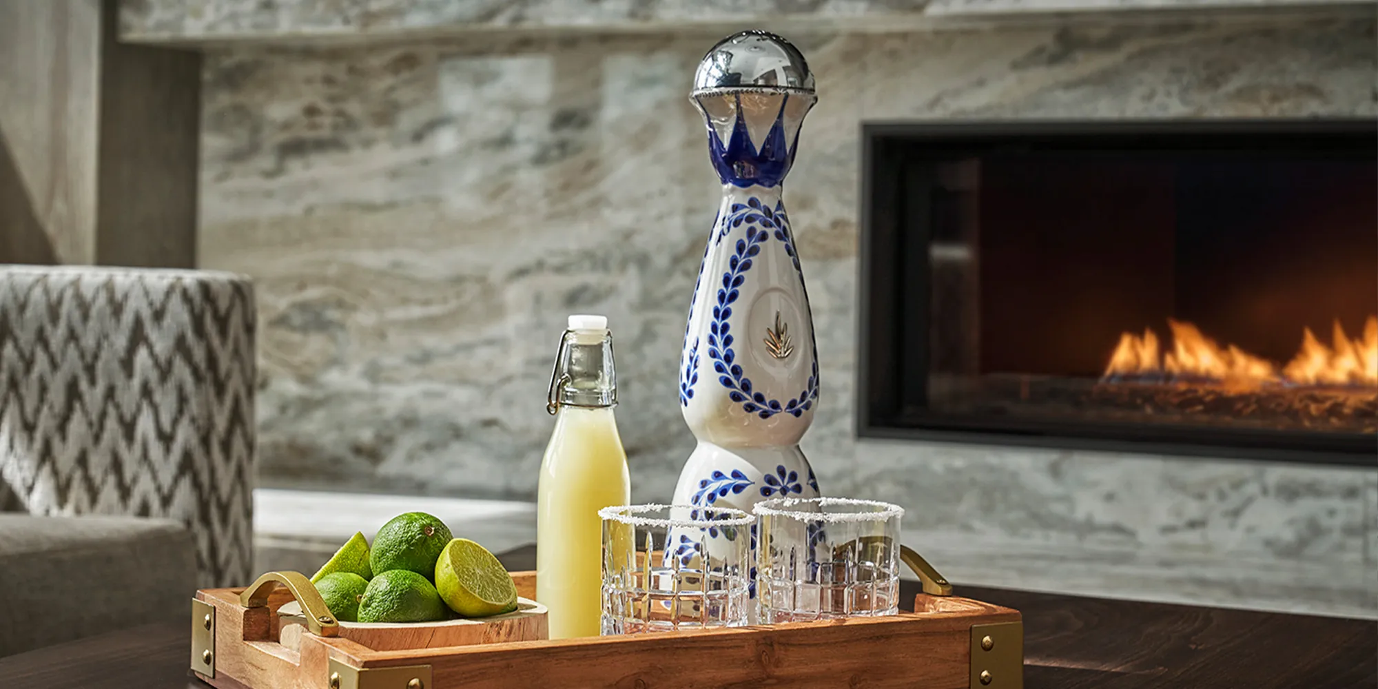 Bottle of Clase Azul Tequila Reposado and margarita glasses on a tray