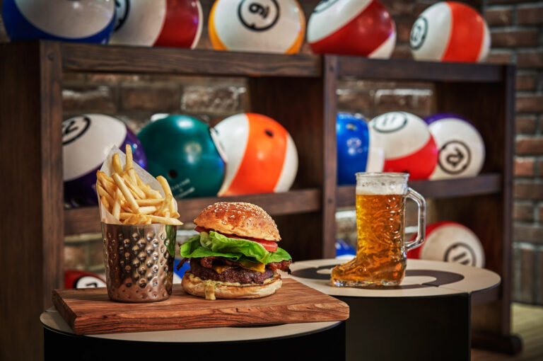 A delicious burger, fries, and beer served in the Beartooth Rec & Pub bowling alley.