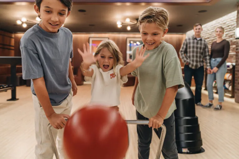 Three children bowling