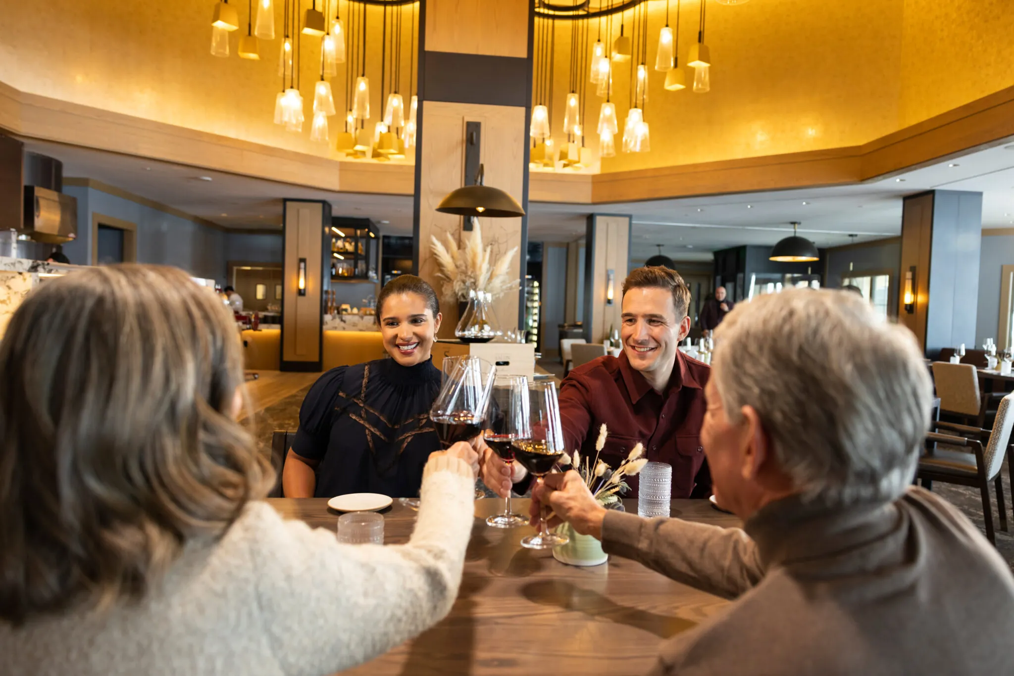 A family of four cheers in Cortina at Montage Big Sky.