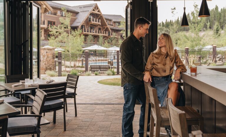 A couple enjoying Backcast at the bar in summer