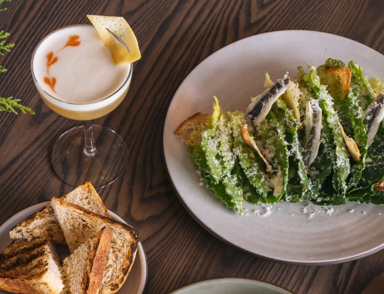 Plates of food with a cocktail at Cortina