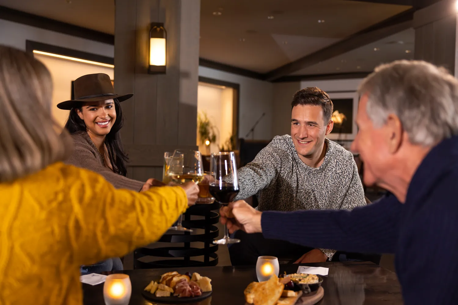 Family clinking glasses of wine together at Alpenglow