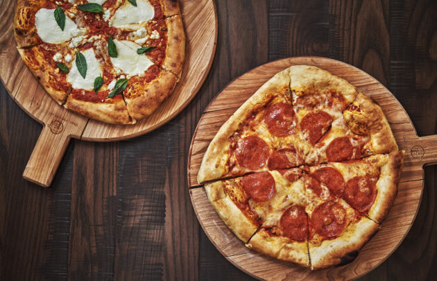 Two pizzas on a table at Beartooth Pub and Rec