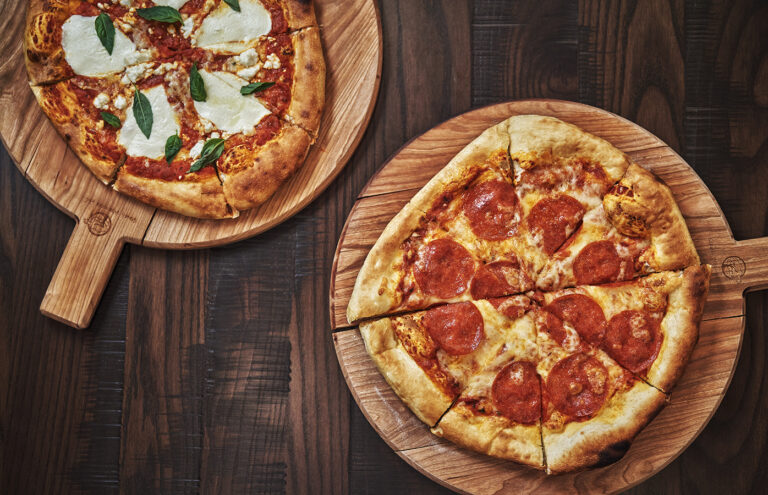 Two pizzas on a table at Beartooth Pub and Rec