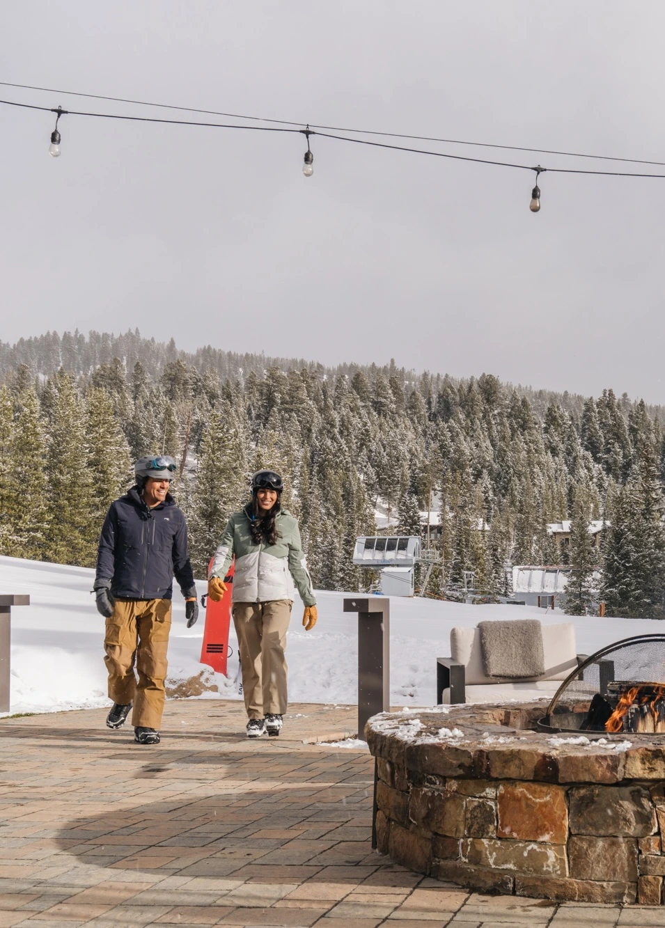 Couple walking up to a fire pit at Backcast