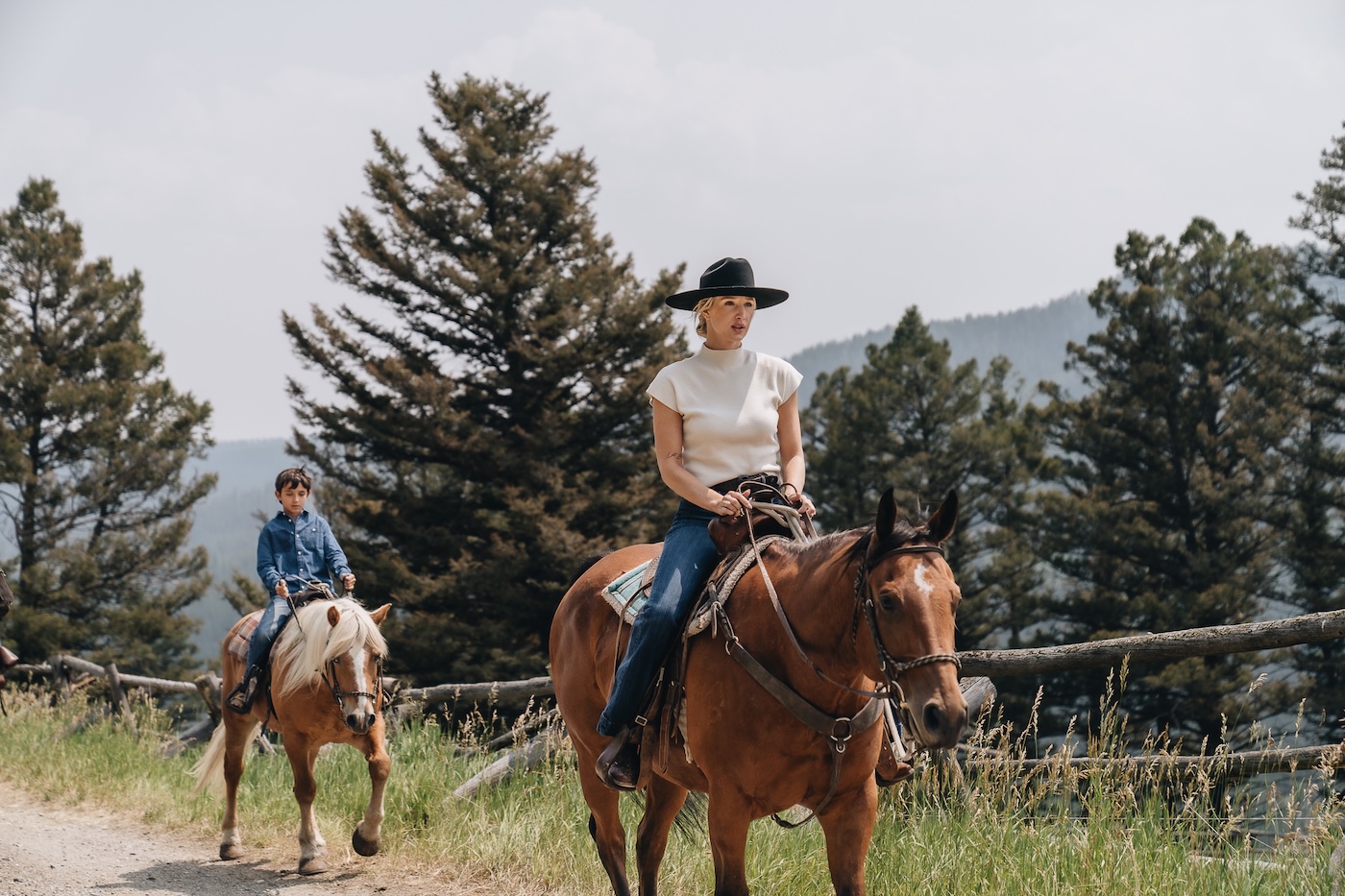 Two people horseback riding