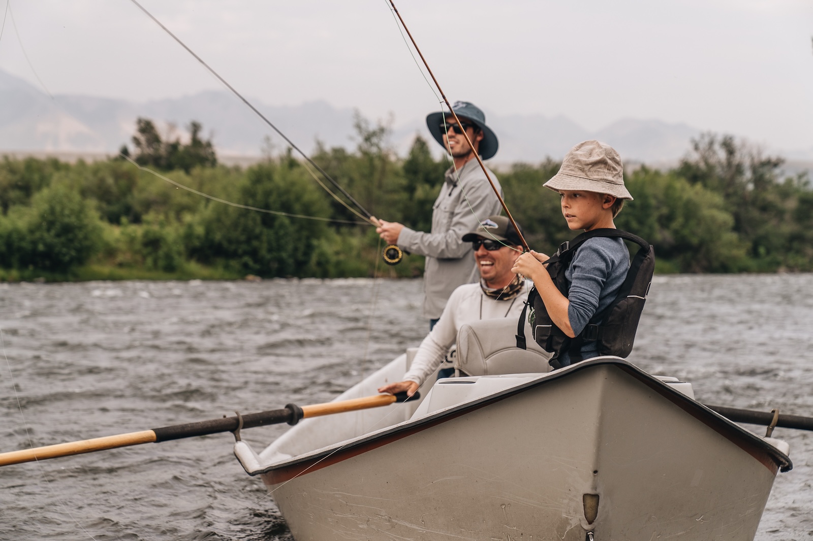 Three people fly fishing