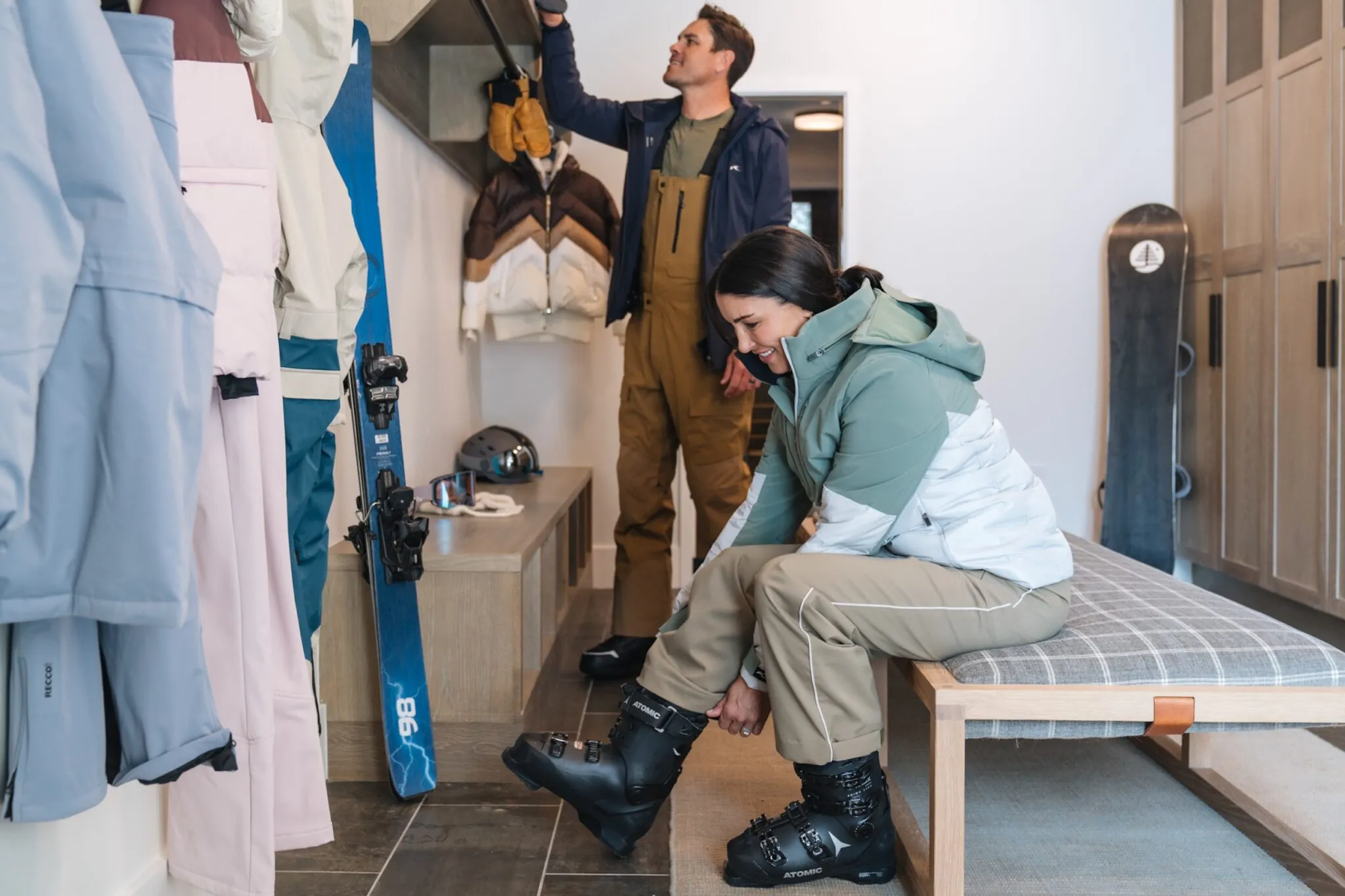 Couple putting on ski gear