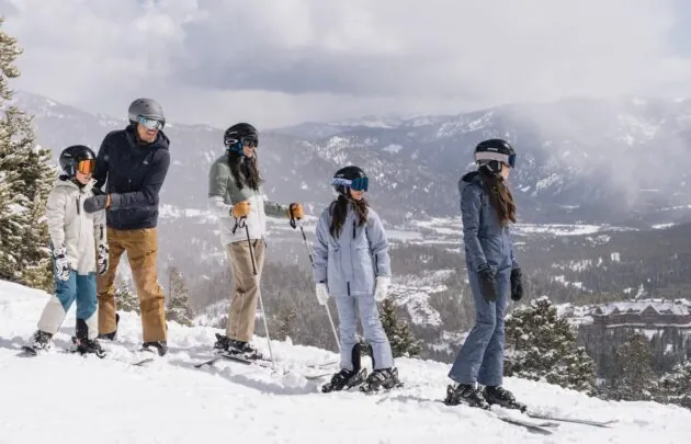 Family skiing together on a snowy mountain
