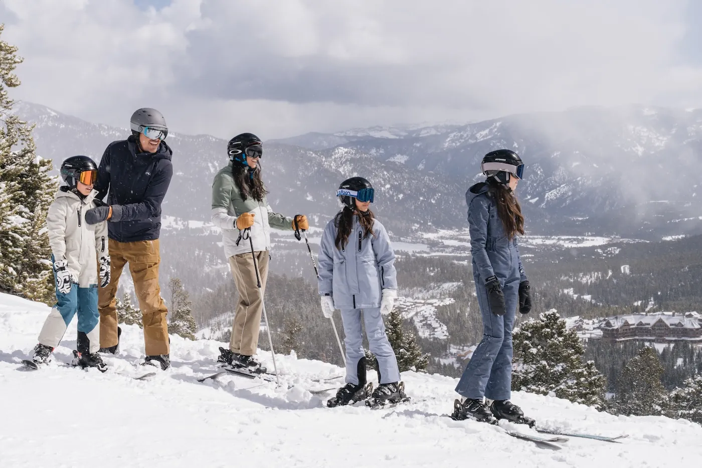 Family skiing together on a snowy mountain