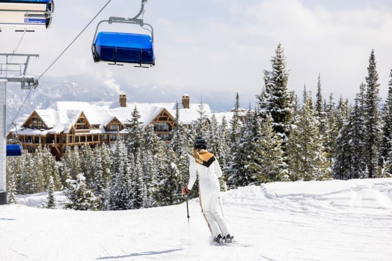 Skier riding near a lodge