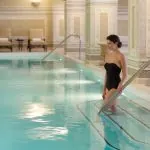 Woman entering spa pool