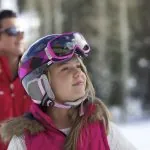 Young girl 7-9 outside, father in background