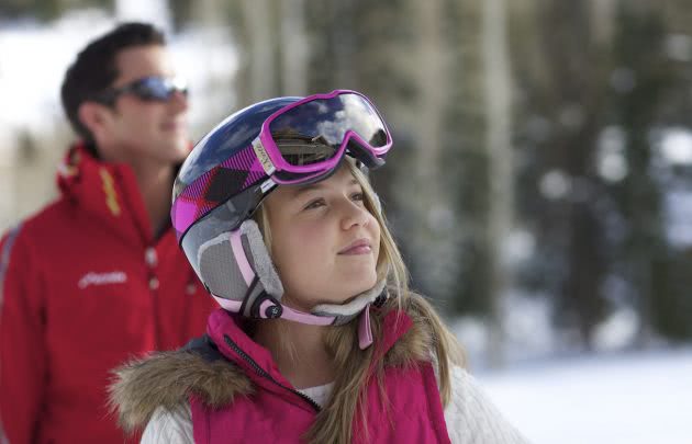 Young girl 7-9 outside, father in background
