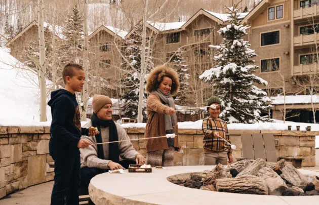 Family making s'mores during winter at Montage Deer Valley