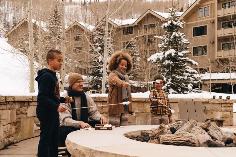 Family making s'mores during winter at Montage Deer Valley