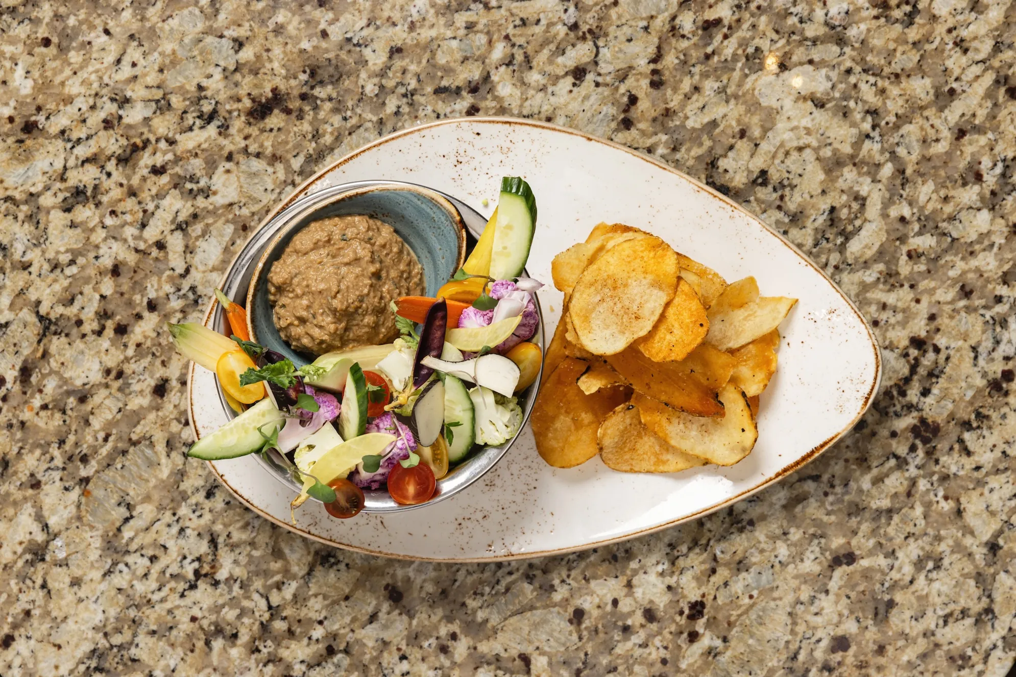 Plate of food at Daly's, including chips and vegetables