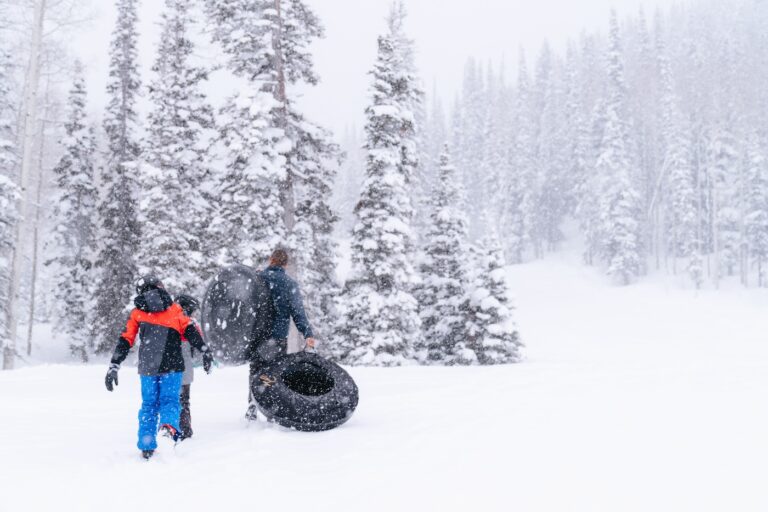 A family tubing in the snow at Montage Deer Valley.
