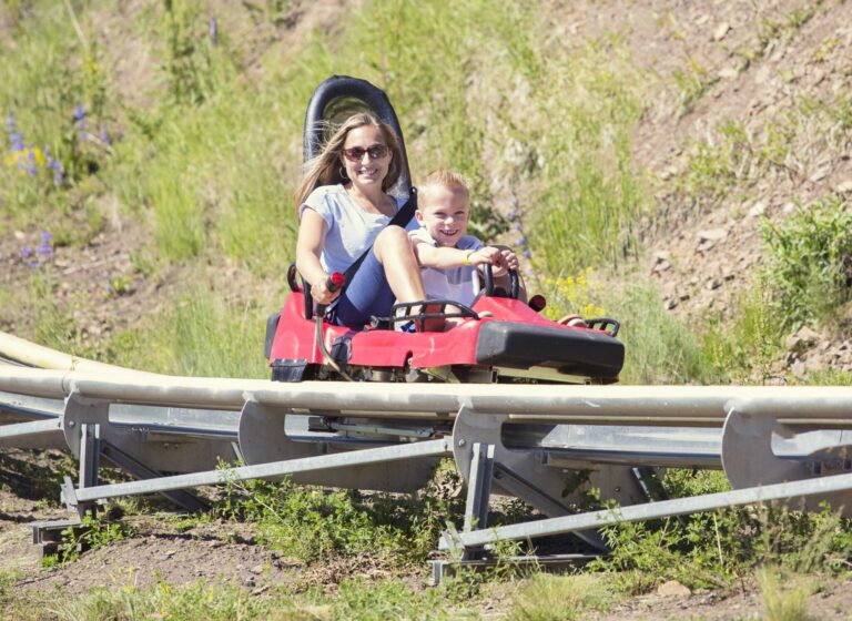 A mother and son on a mountain roller coaster in Park City