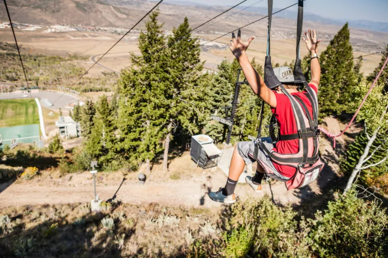 A Man Zip lining at Deer Valley