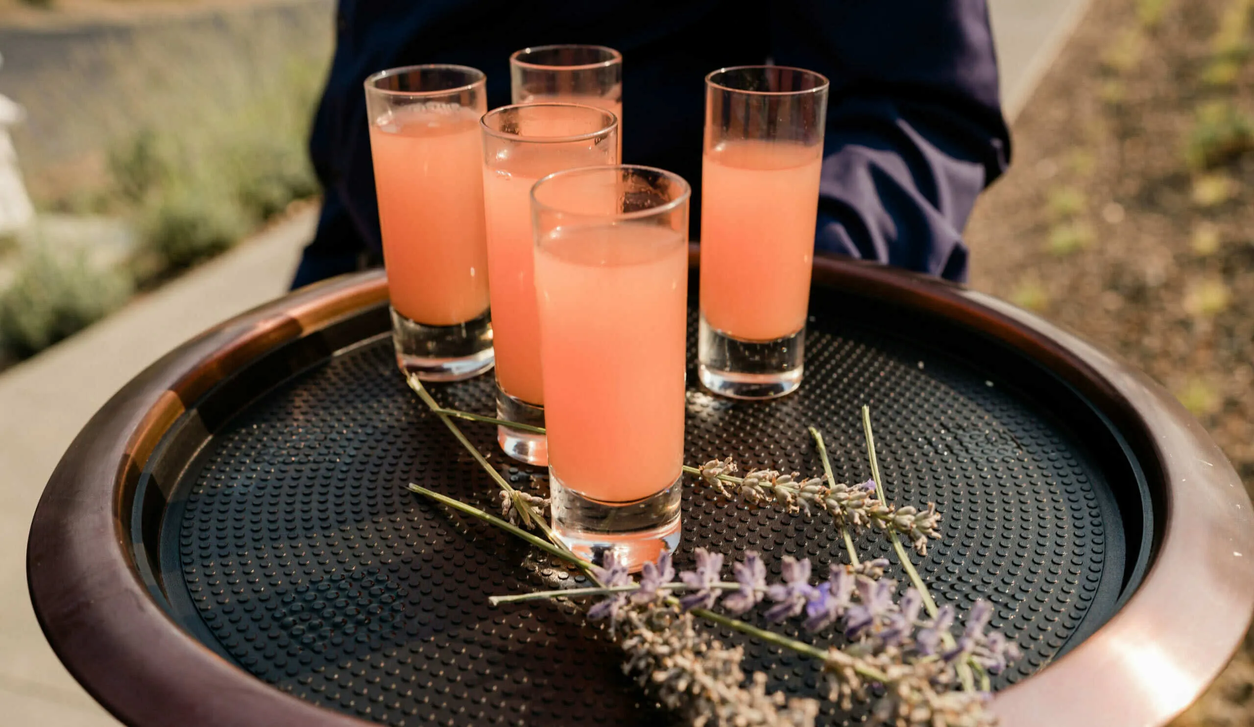 orange drinks with lavender on platter