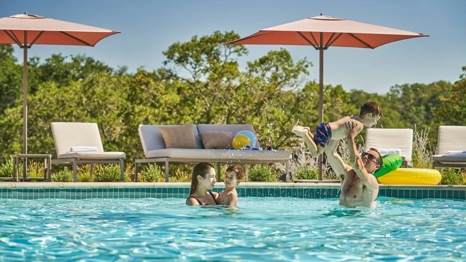 Family playing in the pool at Napa valley resort, Montage Healdsburg