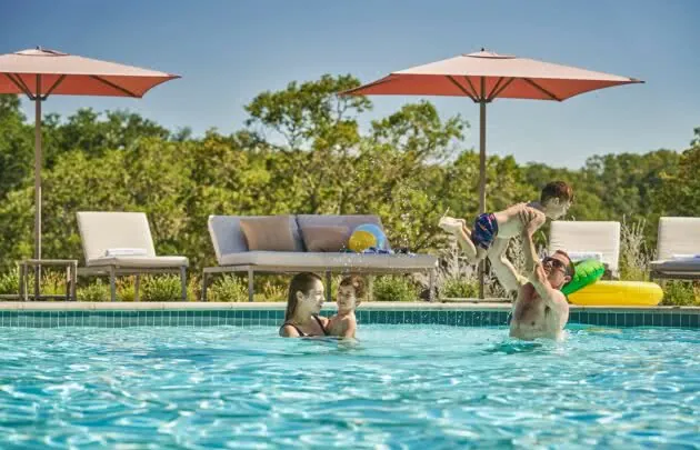 Family playing in the pool at Napa valley resort, Montage Healdsburg