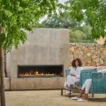A couple resting outside a fireplace at wellness Spa Montage Healdsburg, at a luxury hotel