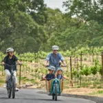 Family biking through napa valley vineyards at luxury resort, Montage Healdsburg