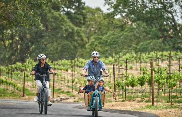 Family biking through napa valley vineyards at luxury resort, Montage Healdsburg