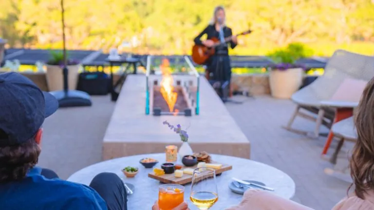 Couple listening to music on Scout Terrace at resort.