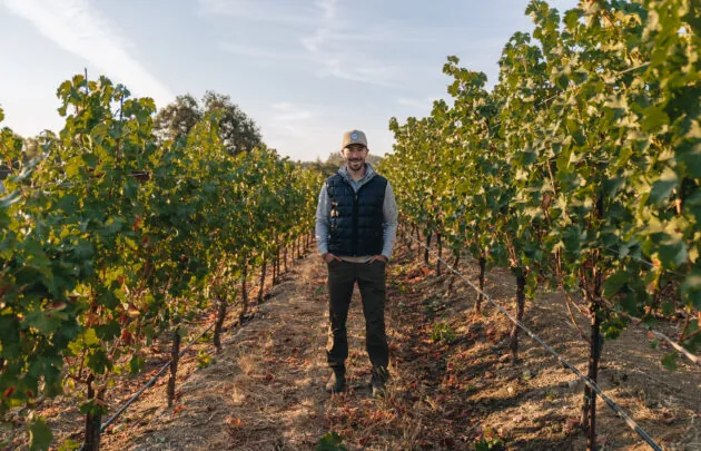 Winemaker standing in the vines.