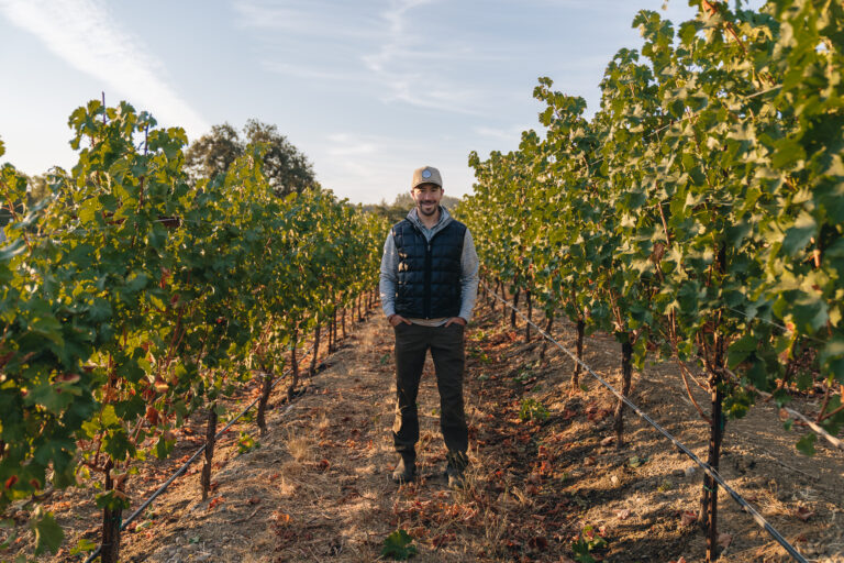Winemaker standing in the vines.