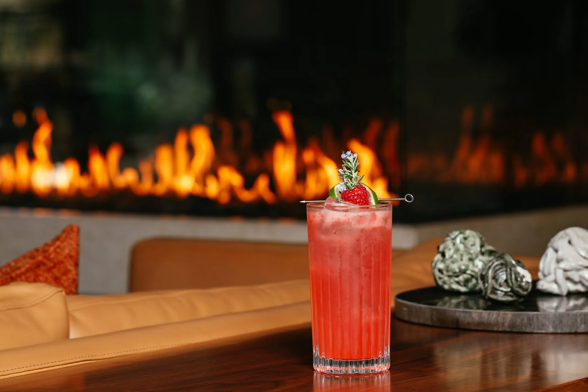 Cocktail at Scout Field Bar with fireplace in the background